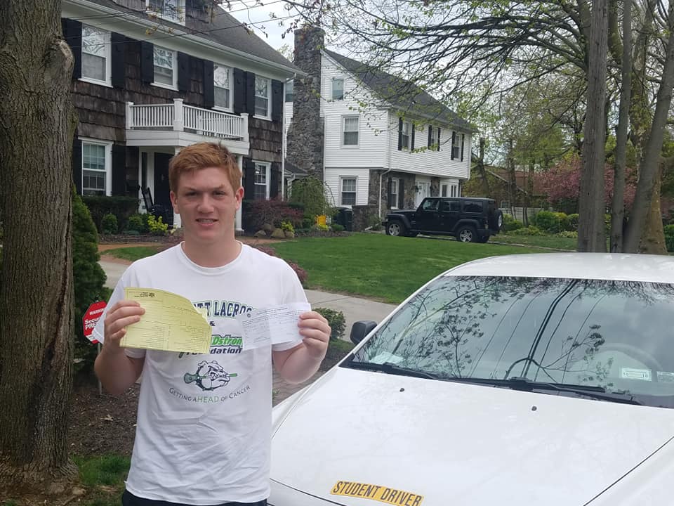Teen driver holding up his certificate after passing our driving class.