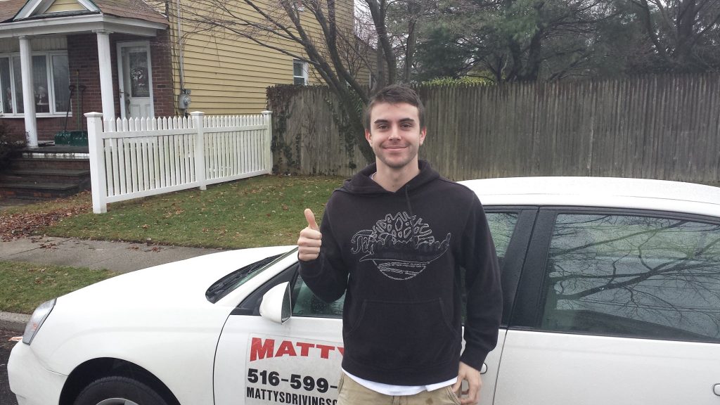Man standing outside one of Matty's cars getting ready to learn safe driving techniques.